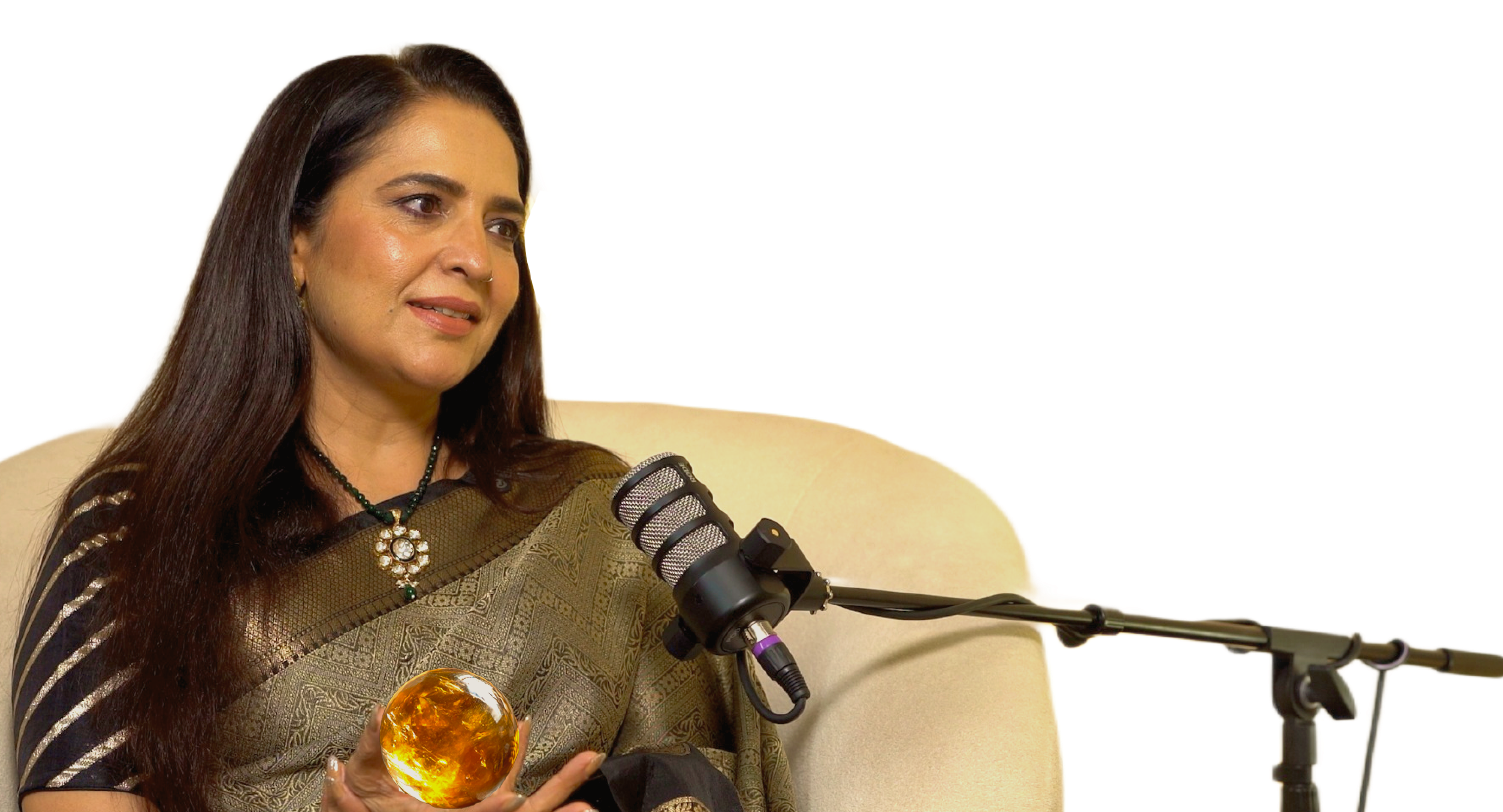 Geeta holding a glowing crystal beside a microphone